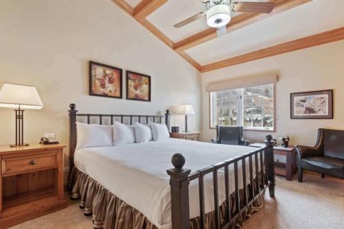 a bedroom with a bed and a chair and a window at The Charter at Beaver Creek F425 in Beaver Creek