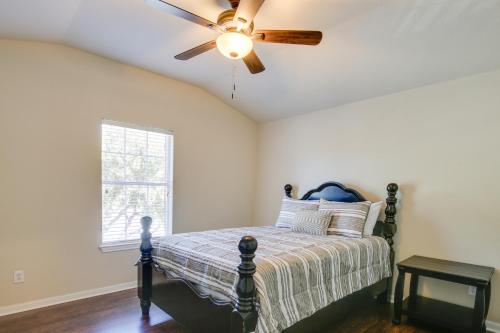 a bedroom with a bed with a ceiling fan at San Antonio Getaway with Deck, Fenced-In Yard! in San Antonio