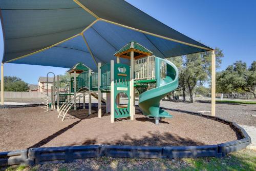 a playground with a slide under a blue umbrella at San Antonio Getaway with Deck, Fenced-In Yard! in San Antonio