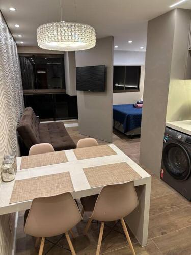 a kitchen with a table and chairs in a room at Flat Life Resort com vista do Lago in Brasilia