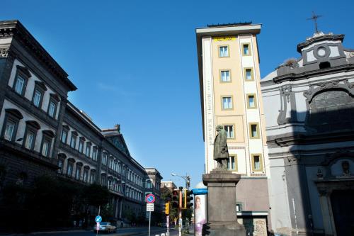 a building with a statue in the middle of a street at Hotel Naples in Naples