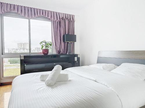 une chambre avec deux lits et un bureau et une fenêtre dans l'établissement 115 - Paris, Appartement luxueux spacieux avec vue panoramique, à Paris