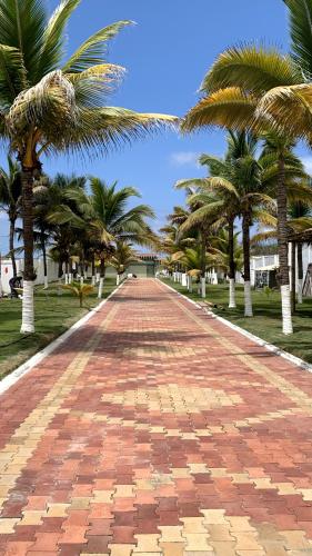 a brick road with palm trees on the sides at Hotel La Mar Playas in Playas