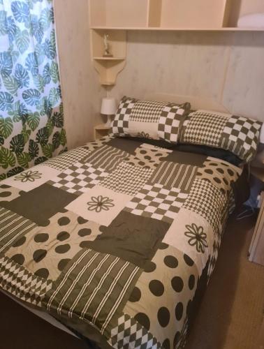 two beds in a room with a bedspread on them at Cozy Cardiff Cabin Retreat sleeps 6 by Aimee in Cardiff