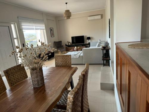 a kitchen and dining room with a table and a couch at Villa Campagna in Kefalos