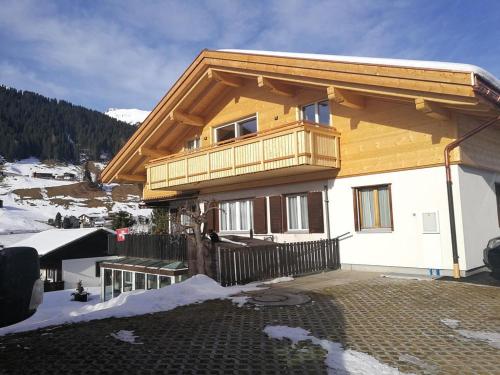 a house with a balcony on top of it at Casa Berger in Bolgen