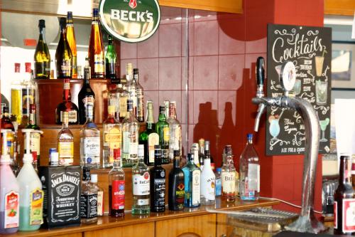 a bar filled with lots of bottles of alcohol at Mediterranean Blue in Kavos