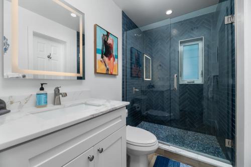 a bathroom with a shower and a sink and a toilet at The Riverside Retreat 2 in Fort Lauderdale