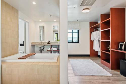 a bathroom with a large tub and a sink at Hotel Casa 425 + Lounge, A Four Sisters Inn in Claremont