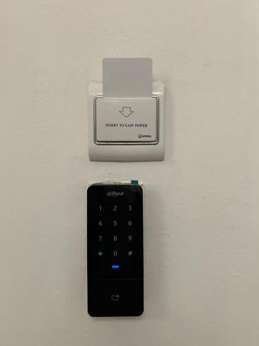 a remote control is attached to a wall at Macedonia Square Apartment in Skopje