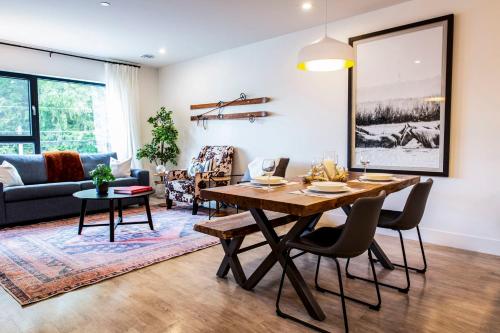 a living room with a table and a couch at Tucker's Place in Revelstoke
