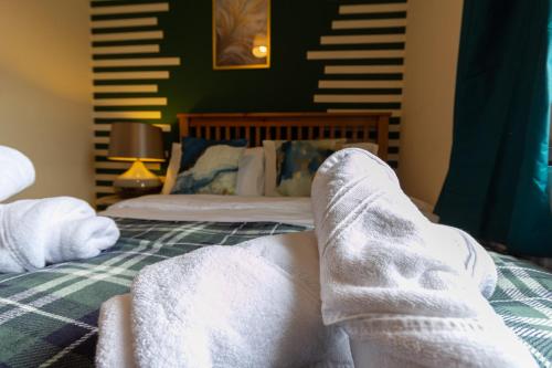 a person with their feet up on a bed at Smart Stays for Busy Days in Stivichall