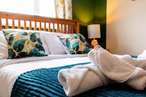 a bedroom with a bed with towels on it at Smart Stays for Busy Days in Stivichall