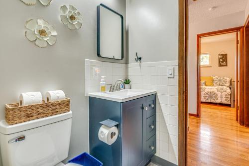 a bathroom with a sink and a toilet with a mirror at Columbus Vacation Rental, 7 Mi to Downtown! in Columbus