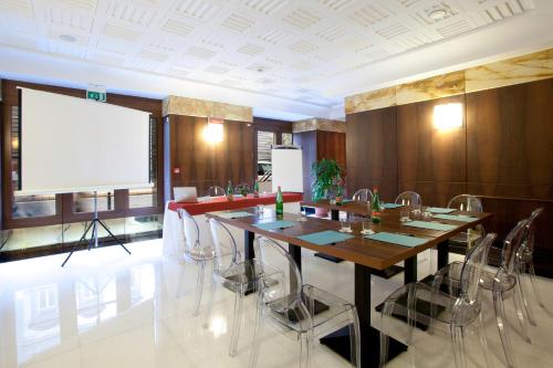a conference room with a large wooden table and chairs at Hotel Naples in Naples