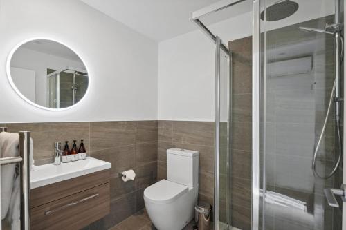 a bathroom with a toilet and a glass shower at Alpine Escape Apartment in Albert Town