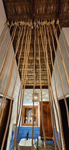 a room with a bunch of ropes hanging from a ceiling at Tapioca Vila Boutique in Atins
