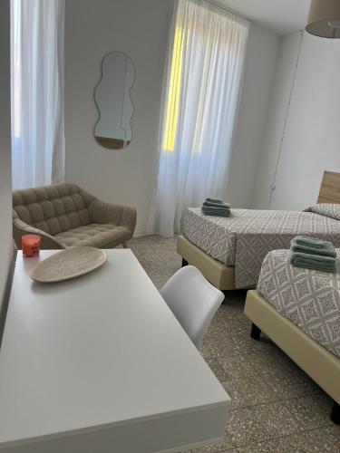 a living room with two beds and a couch and a bed and a couch at Civico 9 in Bonorva