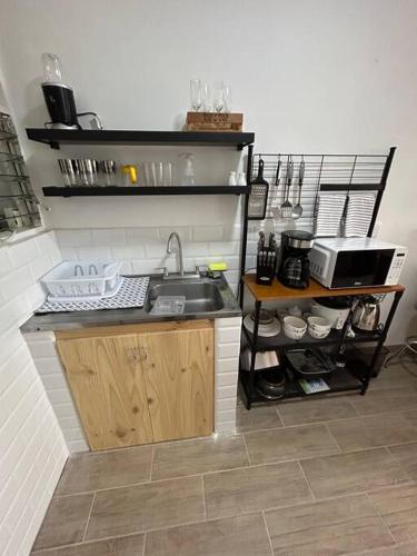a kitchen with a sink and a counter at Apartamento VillaRegis 3 PB, Zapote, San Jose in San José