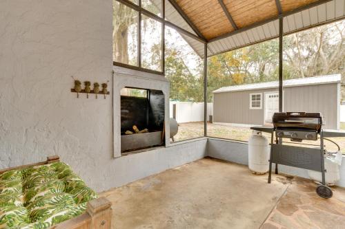 a screened in porch with a fireplace and a grill at Mt Dora Couples Retreat with Shared Pool! in Dublin