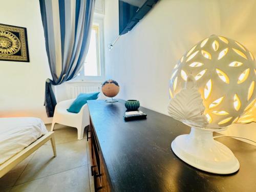 a bedroom with a table with a vase on it at Sibilla in Gallipoli