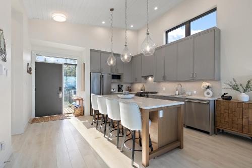 a kitchen with a large island with bar stools at Beachfront Villa #14 at The Beach House in Campbell River