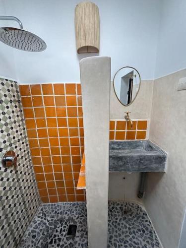 a bathroom with a sink and a mirror at Dar Edouard in Sidi Kaouki