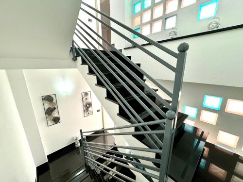 a spiral staircase in a building with windows at B&B Blue in Terrasini