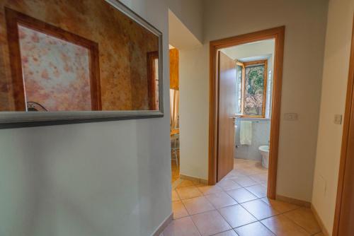 a hallway with a mirror and a bathroom at Windrose Blue Home in Sant'Ermo
