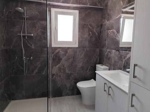 a bathroom with a shower and a toilet and a sink at Marina view seaside apartment in Larnaka