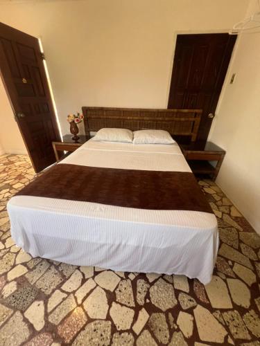 a bedroom with a large bed in a room at Cozy Family Inn in Port Antonio
