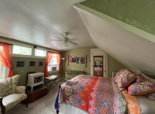 a bedroom with a bed and a ceiling fan at Admiral Peary Inn in Fryeburg