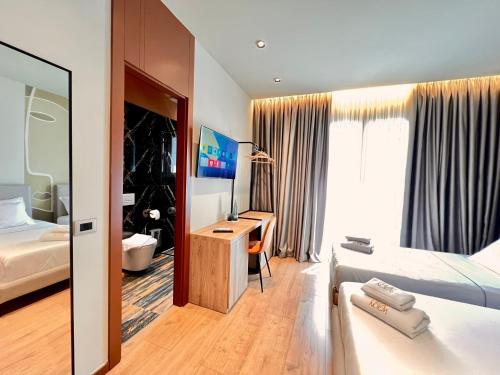 a hotel room with a bed and a desk in it at Villa Noem in Tirana