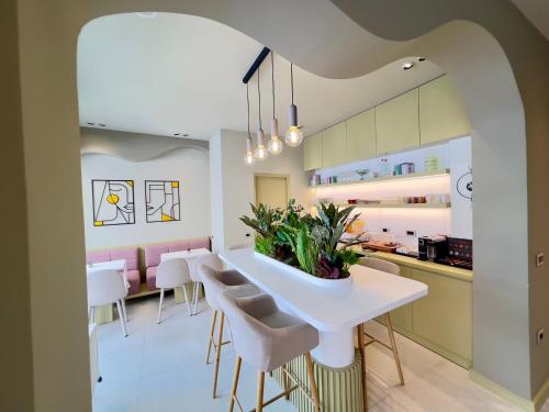 a kitchen with a white table and chairs at Villa Noem in Tirana