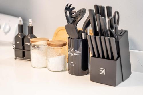 a block of knives and utensils on a counter at Spacious 5B2B home 5 min to airport with AC, Game Room, WiFi, Parking in SeaTac