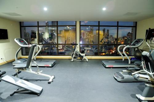a gym with cardio equipment and a view of the city at Best Western Plus Panama Zen Hotel in Panama City