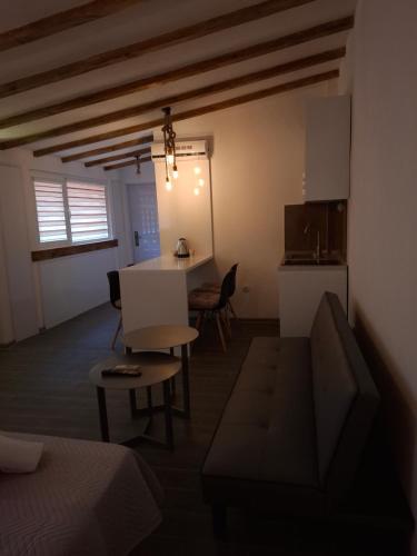 a living room with a couch and a table and a kitchen at Z&G Apartment in Bitola