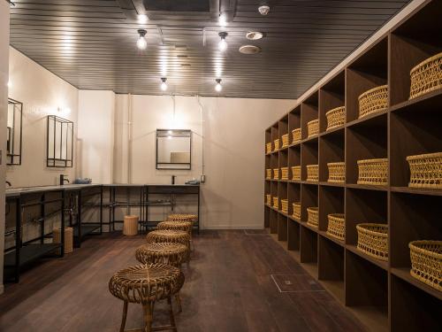 a row of stools in a room with shelves at Irifuneso in Ureshino