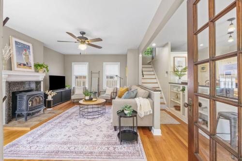 a living room with a couch and a fireplace at The Knocking Bird- Mins to CLE Clinic in Cleveland Heights