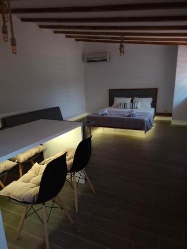 a bedroom with a bed and a table and chairs at Z&G Apartment in Bitola