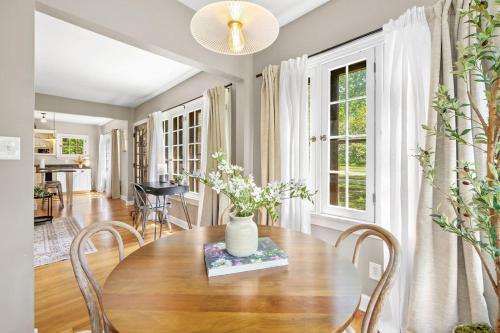 a dining room with a table with chairs and a vase on it at The Knocking Bird- Mins to CLE Clinic in Cleveland Heights