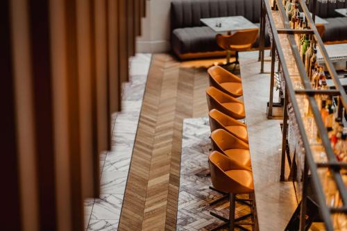 a row of chairs in a room with a table at Radisson Blu Hotel, Glasgow in Glasgow