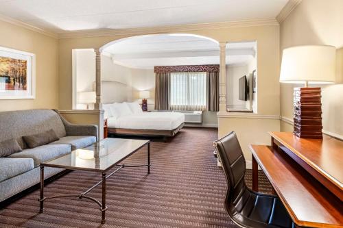 a hotel room with a couch and a bed at Best Western Springfield Hotel in Springfield