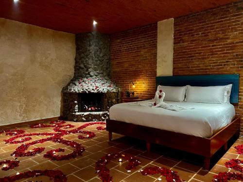 a bedroom with a bed and a fireplace with christmas decorations at Le Suisse Spa in Santa Lucía Milpas Altas