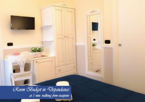 a bedroom with a bed and a desk and a tv at Bed & Breakfast Medea in Naples