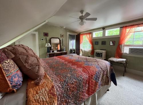 a bedroom with a bed and a ceiling fan at Admiral Peary Inn in Fryeburg