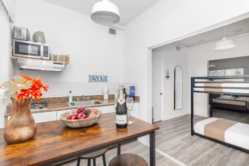 a kitchen with a table with a bowl of fruit at West Deco in Miami Beach