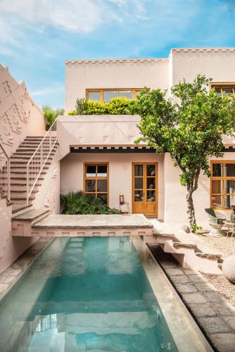 a house with a swimming pool in front of a house at La Valise San Miguel de Allende, Member of Small Luxury Hotels in San Miguel de Allende