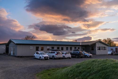 a group of cars parked in front of a building at Vogar Travel Service in Myvatn