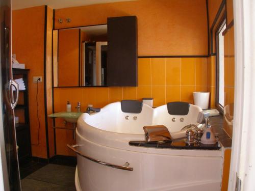 a bathroom with a white tub and a sink at Vistas de Ronda in Ronda